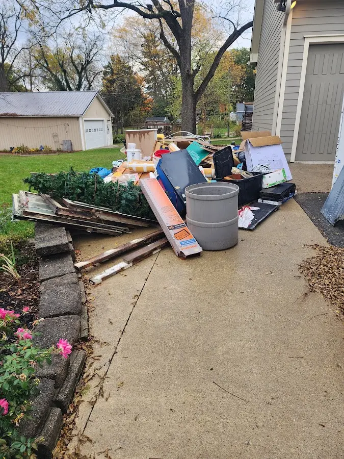 Dumpster being loaded with debris for Commercial Dumpster Rental in Escatawpa